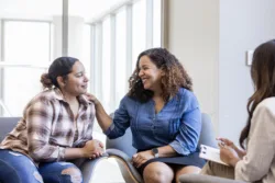 After telling the therapist how much she loves her daughter, the mother puts her hand on her shoulder and smiles proudly about how far shes come in recovery