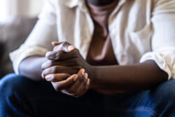 African American male sitting with hands clasped during a counseling session in a partial hospitalization program