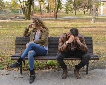 couple not talking to each other on bench