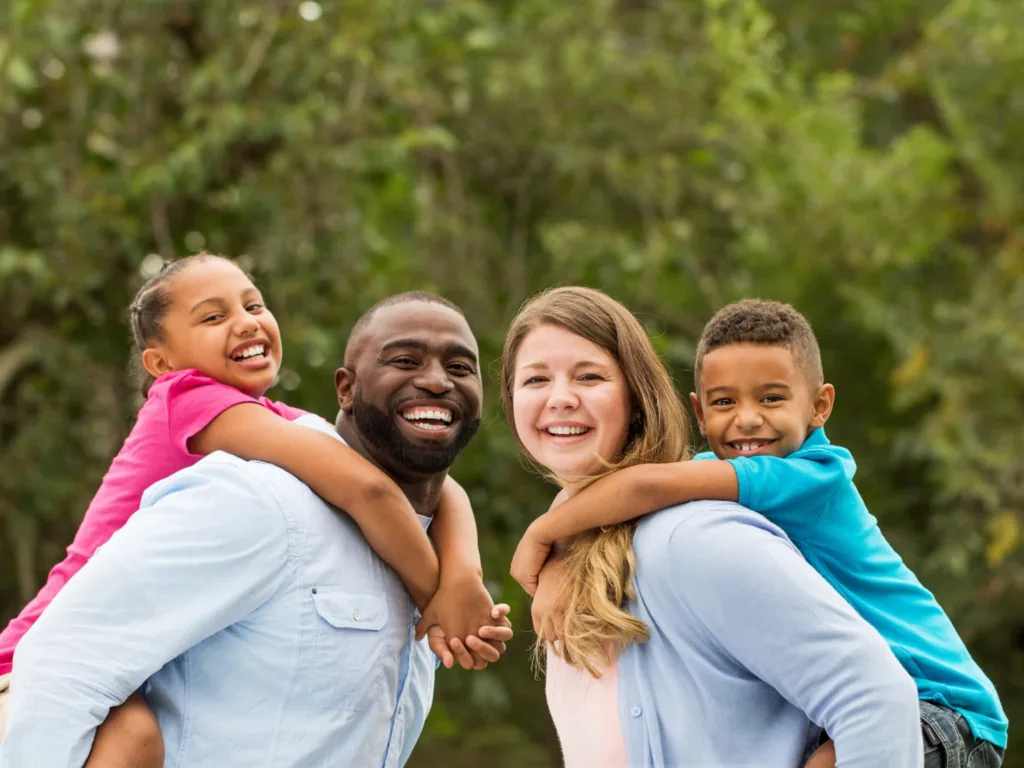 A bi-racial family with a father, mother, daughter and son