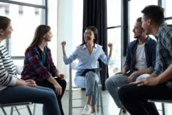 Psychotherapist working with patients in group therapy session.