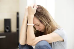 depressed teenager sitting down