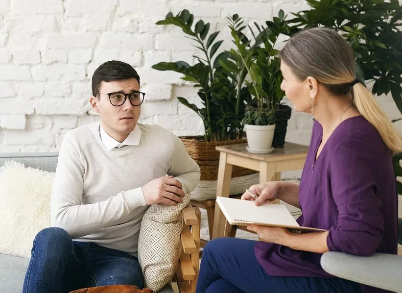 Senior Woman Psychotherapist Or Counselor Writing Something Down