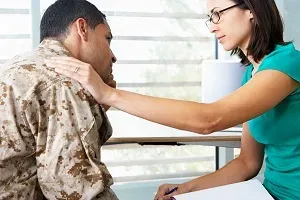 woman putting hand on man's shoulder