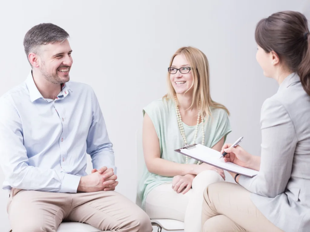A man and woman talk with a therapist