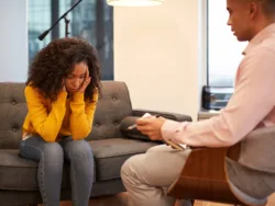 A woman talks with her therapist in an addiction counseling session