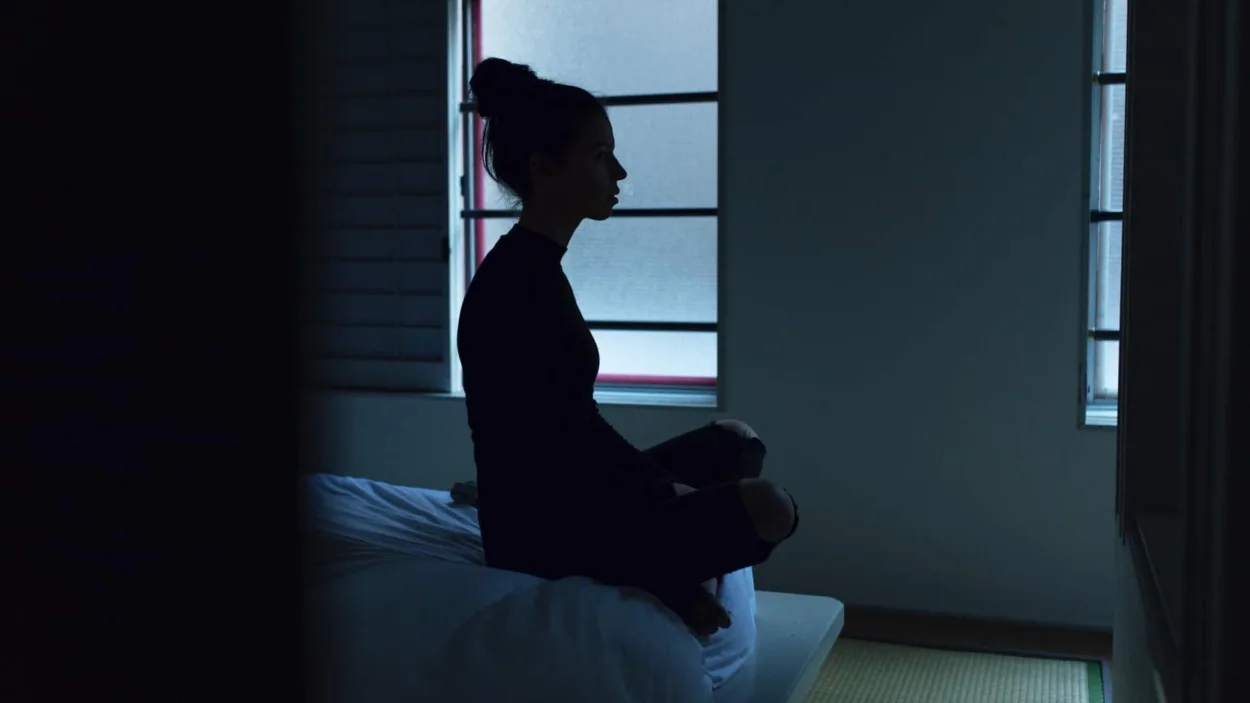 woman staring at wall