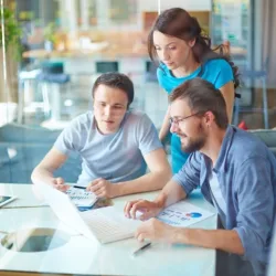 effectively juggling responsibilities and rehab group of workers looking at laptop