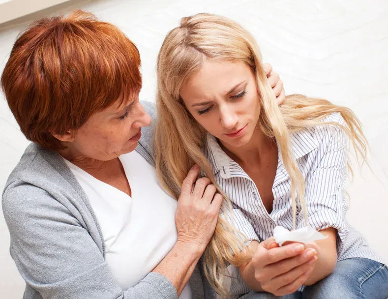 mother comforting daughter