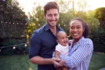 Portrait Of Family With Baby Son At Home Outdoors In Garden Portrait Of Family With Baby Son At Home Outdoors In Garden