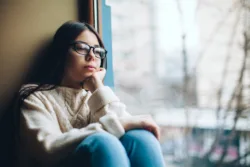 Sad teen looking out window