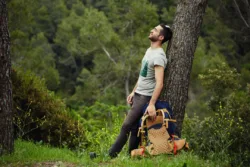 Having Fun in Recovery man leaning against tree