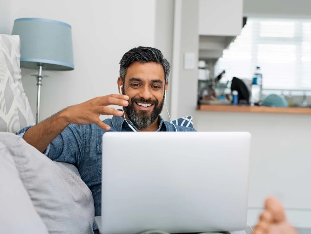 A man talks with his addiction counselor over video chat