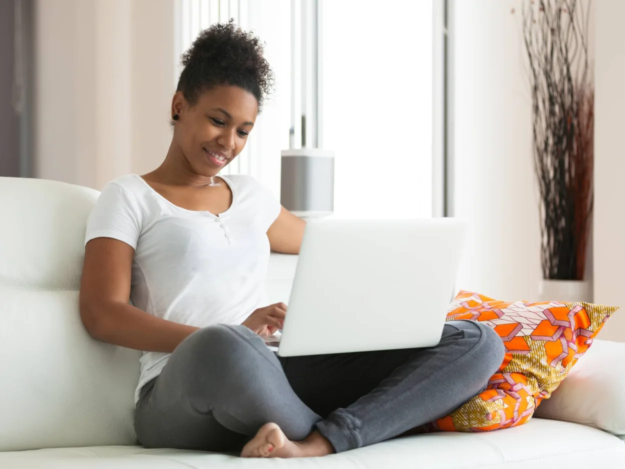 A woman talks to her counselor over video chat using a telehealth platform