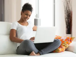 A woman talks to her counselor over video chat using a telehealth platform