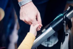 child hand grabbing parent hand