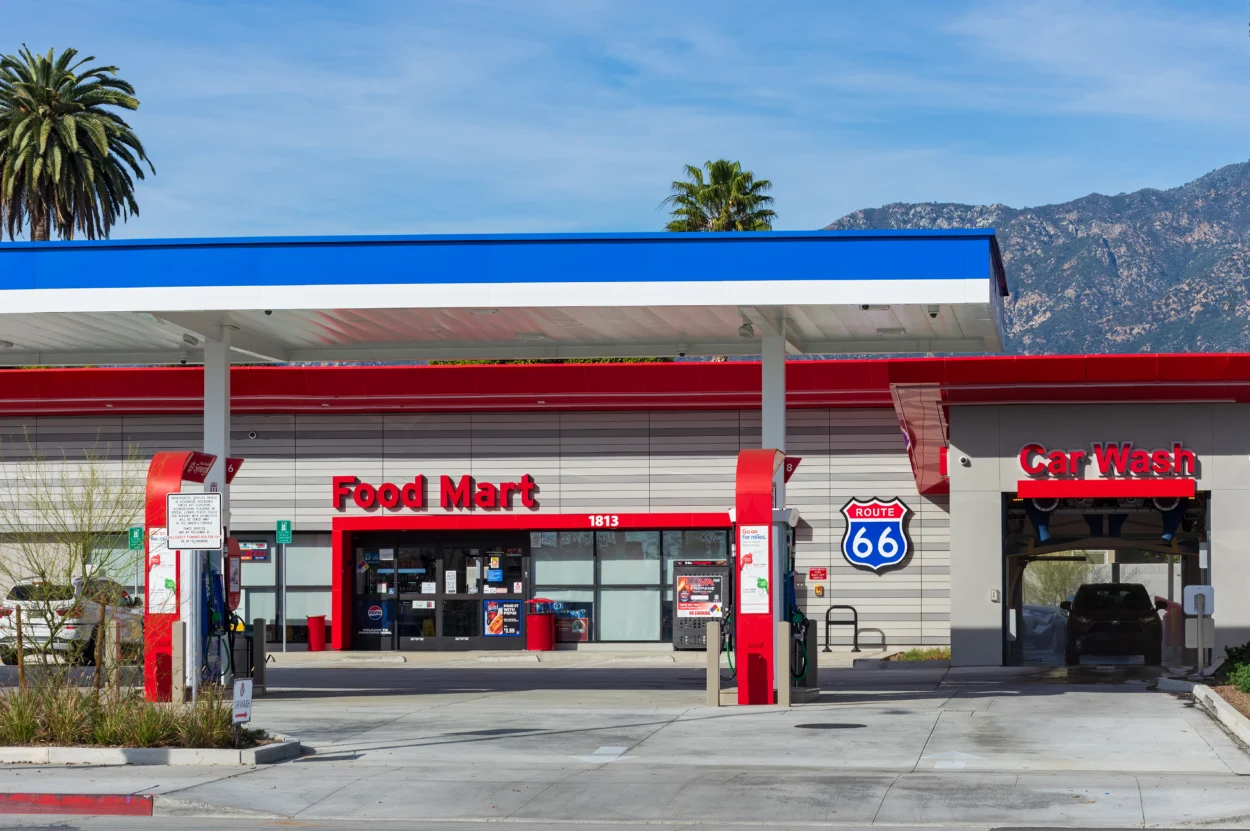 picture of the outside of a gas station food mart