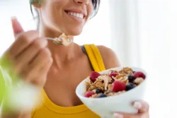 portrait-of-beautiful-young-woman-eating-cereals-and-fruits-at-home-stockpack-istock Portrait of beautiful young woman eating cereals and fruits at home.