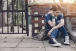 teenager with headphones sitting alone