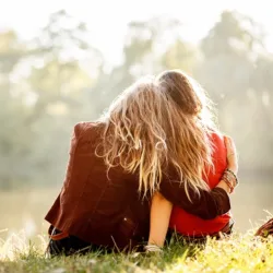 females hugging while sitting