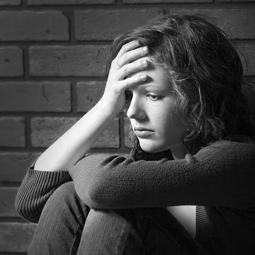 woman sitting against wall