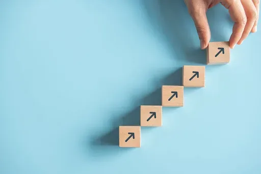 Wooden blocks with arrows trending upward