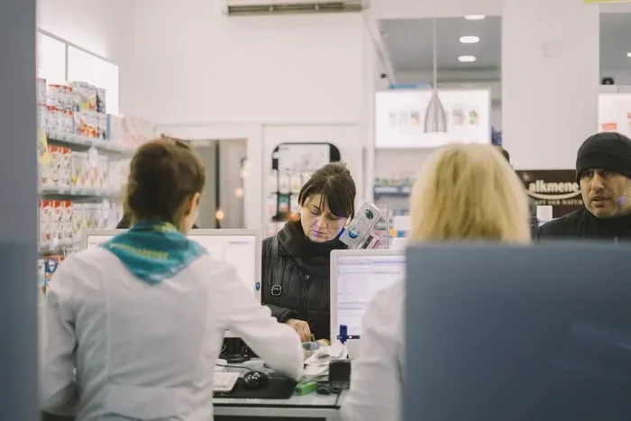 People waiting in line to fill prescriptions at a pharmacy