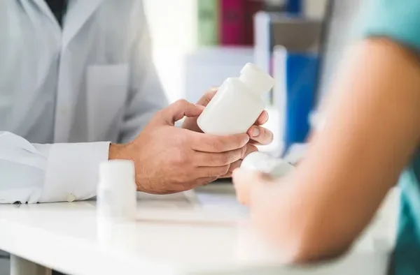 A man examines a prescription medication that has been legally prescribed to him.
