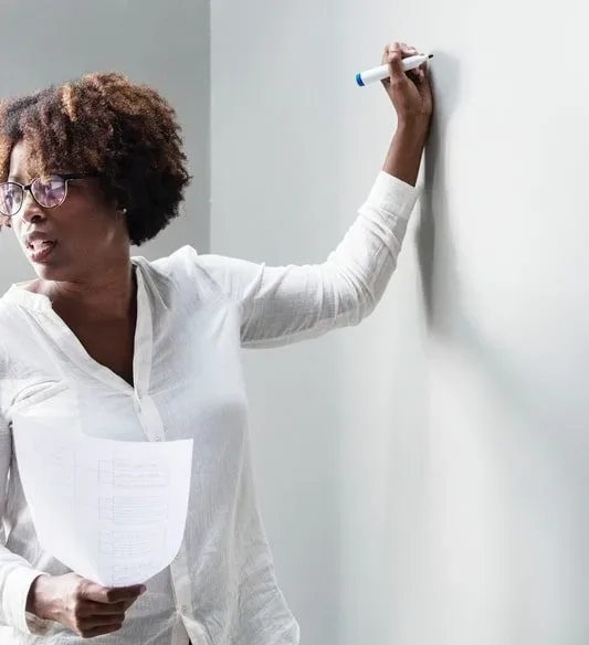 woman writing on whiteboard