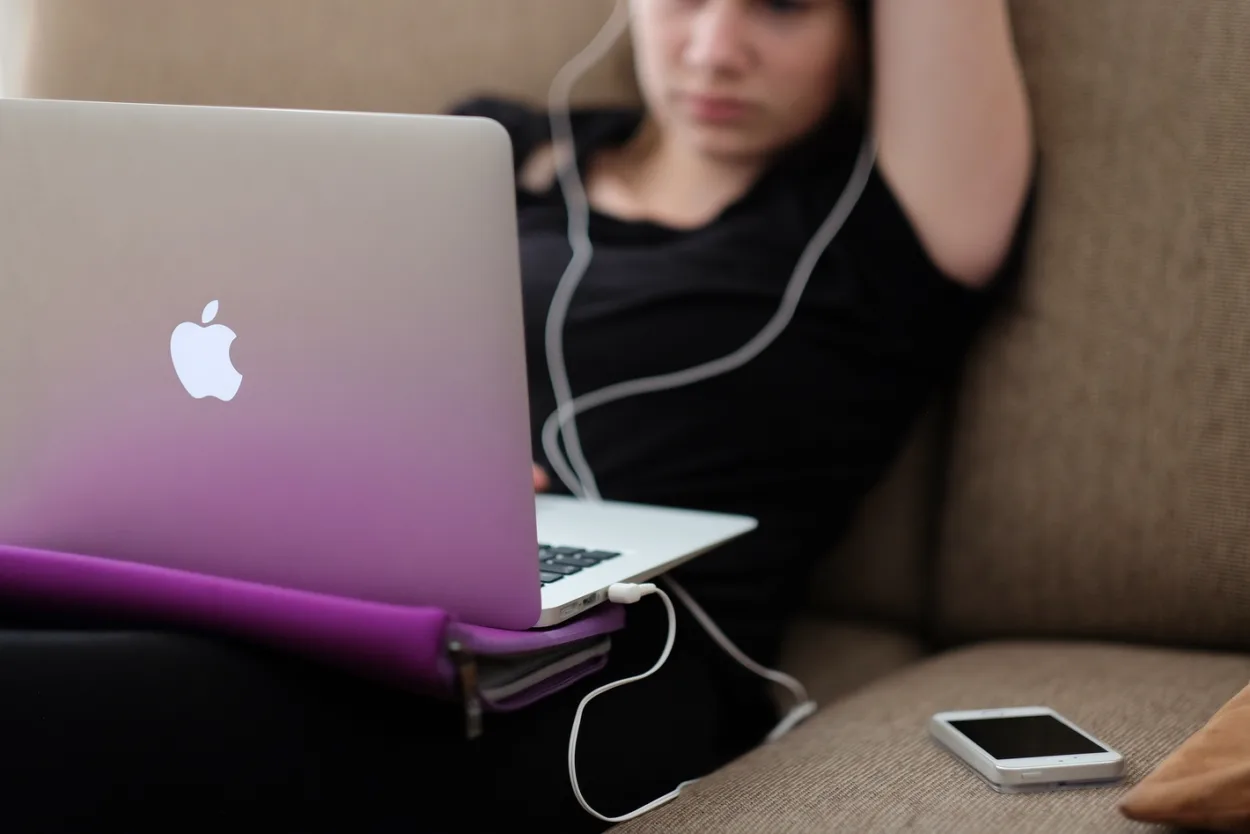 woman using laptop while sitting