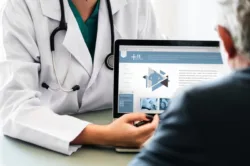 doctor showing patient computer screen