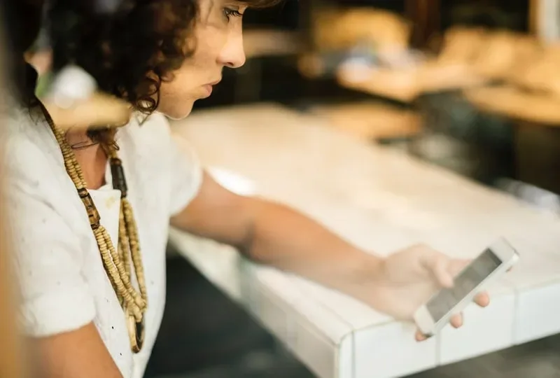 woman using online dating app on phone