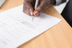 man signing a Return to Work agreement